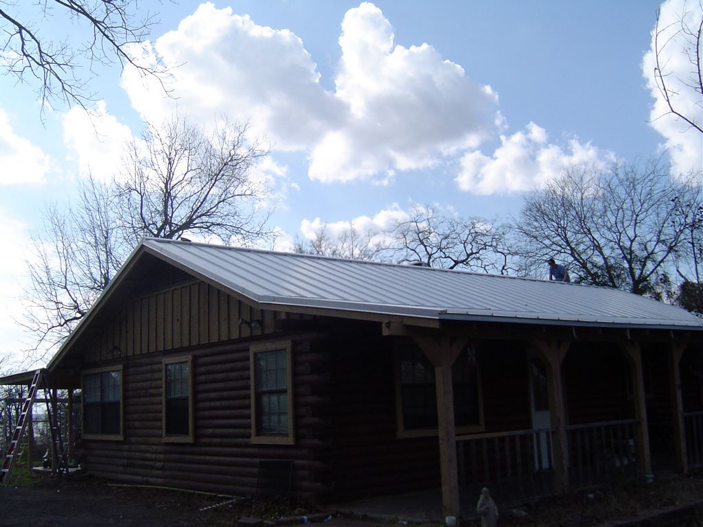 Metal roof panels and ridge trim on a commercial building roofed by A Classic Roofing